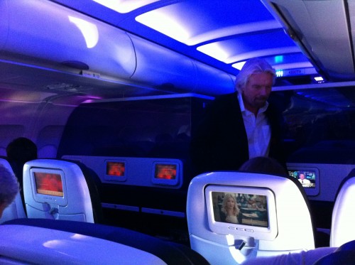 Sir Richard Branson goes down the aisle on Virgin America's inaugural flight from San Francisco to Palm Springs. Photo by Nick Smith, AirlineReporter.com