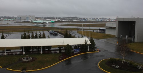 Emirates Boeing 777-300ER taking off from Paine Field on Jan 26, 2013. Taken from the Hilton Garden Inn and that is the Future of Flight to the right. CLICK FOR LARGER.