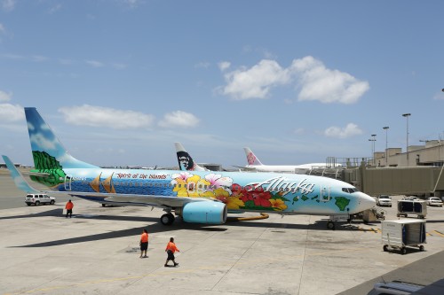 CLICK IMAGE FOR LARGER. Image and press release from Alaska Airlines: HONOLULU  A specially painted Alaska Airlines jet adorned with a Honolulu high school student's winning design honoring the culture of the Aloha State touched down today in Honolulu before a crowd of students, educators and travelers. The unique paint theme, dubbed the "Spirit of the Islands," was created by 17-year-old Aaron Nee. Nee's design was selected from among more than 2,700 submissions by students across the Hawaiian Islands in a statewide "Paint-the-Plane" contest sponsored by Alaska Airlines, in partnership with the Hawaii State Department of Education and Hawaii Association of Independent Schools. A 10-member judging panel, comprised of Hawaii artists, educators and other local community members, carefully scored and selected the three top designs, which were then voted on by Hawaii residents in an online public vote. As the grand prize winner, Nee received a trip for four to any of the carrier's destinations and a $5,000 scholarship. "This has been an incredible opportunity to share Hawaii's beauty with people throughout the country," said Nee. "This contest helped me to sharpen my graphic design skills and demonstrated that with hard work, attention to detail and determination, great things are possible." Nee's winning design displays a voyaging canoe depicting the cultural diversity of the Islands, a bright yellow hibiscus (the state flower), the Hawaiian Island chain and the phrase "Spirit of the Islands." The soon-to-be Kaiser High School senior is a nearly straight-A student and a decorated member of the school's Air Force ROTC program. Known for his artistic ability and interest in graphic design and athletics, Nee said he plans to invest his $5,000 for college and take his family to visit relatives in New York, where he hopes to see snow for the first time. The "Spirit of the Islands" Boeing 737-800 was revealed to Nee at Honolulu International Airport, where he was joined by his parents, Robin and Mitch Connell, and father Aaron Garrett Nee, as well as Hawaii Lt. Gov. Shan Tsutsui, Hawaii Tourism Authority President and CEO Mike McCartney, Kaiser High School Principal John Sosa and several of Nee's teachers. Also joining the welcoming ceremony were the 12 finalists and honorable mention winners, who received prizes and scholarships for their entries, as well. "What better way to celebrate the beautiful Hawaiian Islands than to promote its lush tropical landscape, cultural diversity and pristine waters on a flying mural that will tour most of our route network from Hawaii to San Diego, and to Boston and beyond," said Alaska Airlines President and CEO Brad Tilden. "On behalf of all of Alaska Airlines employees, I'd like to congratulate Aaron and the other 12 finalists and honorable mention winners whose stunning artwork stood out as the best among their peers." Izabela Hamilton, a 12th grader at Seabury Hall on the island of Maui, placed second for her design featuring a male and female hula dancer against a backdrop of ocean waves and windswept mountain cliffs. Sophia Cleek, a sixth grader at Kapolei Middle School on Oahu, placed third for her design depicting a voyaging canoe sailing around the Islands. Hamilton and Cleek will each receive a trip for four to any Alaska Airlines destination and a $1,000 scholarship. The 10 other honorable mention winners were awarded a $1,000 scholarship each. A dedicated website, www.alaskaair.com/hawaii, highlights the top 13 student designs submitted for the contest. "Congratulations to Aaron and the other students who are sharing the true spirit of the Islands through their designs," said Schools Superintendent Kathryn Matayoshi, Hawaii State Department of Education. "We are grateful to Alaska Airlines for providing this opportunity for our students to shine." "Spirit of the Islands" trivia "¢ The 129-foot-long Boeing 737-800 has a wingspan of 117 feet and a cruising speed of 530 mph. "¢ A crew of 18 worked around the clock for 24 days at Aviation Technical Services in Everett, Wash., to paint the plane, which required 26 colors and about 140 gallons of paint, including 20 gallons of primer. In addition, 28,800 yards of masking tape were used. "¢ The plane accommodates 157 passengers and six crew members.