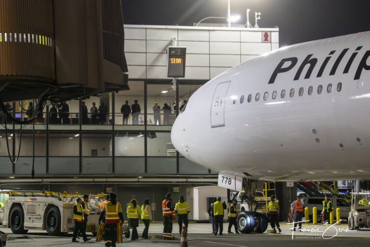 Passengers and airport staff crowded the terminal windows as the jet arrived at its gate